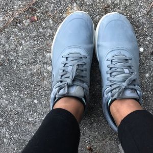 Used shoes with minor scrapes and creasing.